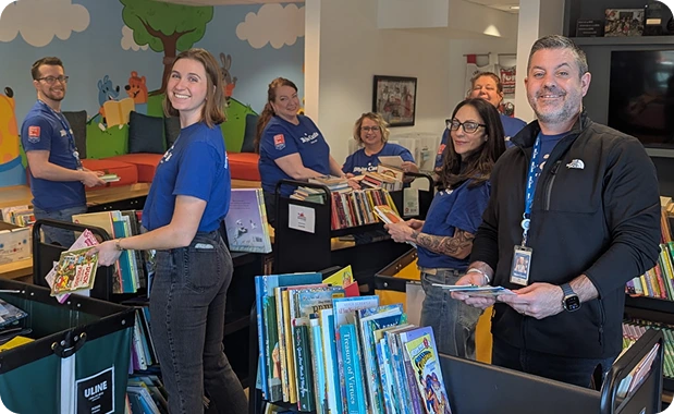 White Castle employees sort and organize children's books during a community volunteer event.