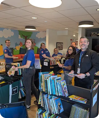 White Castle employees sort and organize children's books during a community volunteer event.