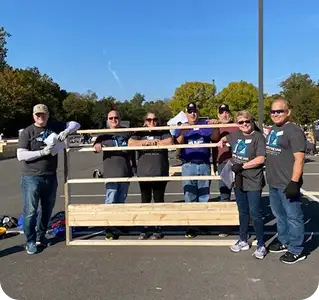 White Castle volunteers pose with a completed project during a community service event outdoors.
